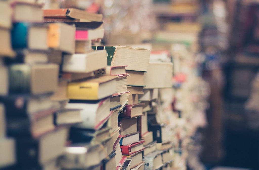 Piles of paperback and hardback books