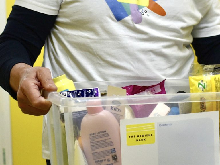 A Hygiene Bank volunteer carrying a box of donated toiletries Image: The Hygiene Bank