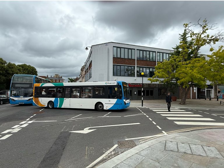 A bus waits patiently as it holds up Bedford High Street traffic while waiting for a pedestrian to cross the road at the Embankment's zebra crossing