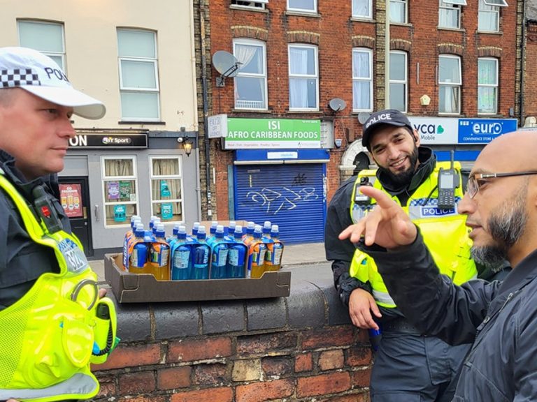 A member of the Queen's Park community speaks with Bedfordshire Police officers after threats of fascist protests. Image: Islam Bedford/Facebook