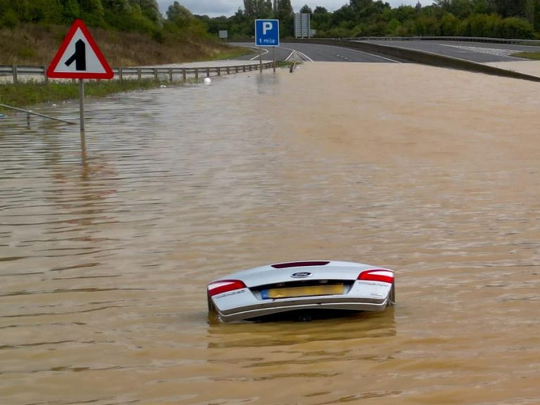 An abandoned car submerged on the flooded A421, 23 September 2024. Image: Cozzas Drone/Facebook
