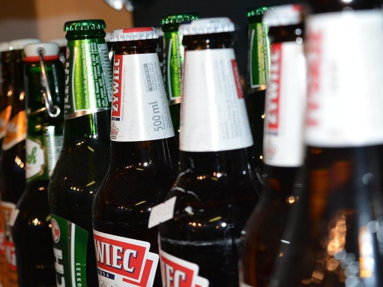 stock image of beer bottles in off licence