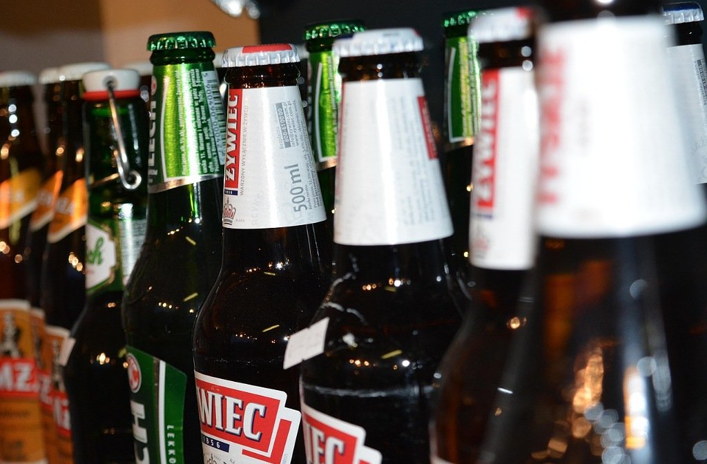 stock image of beer bottles in off licence