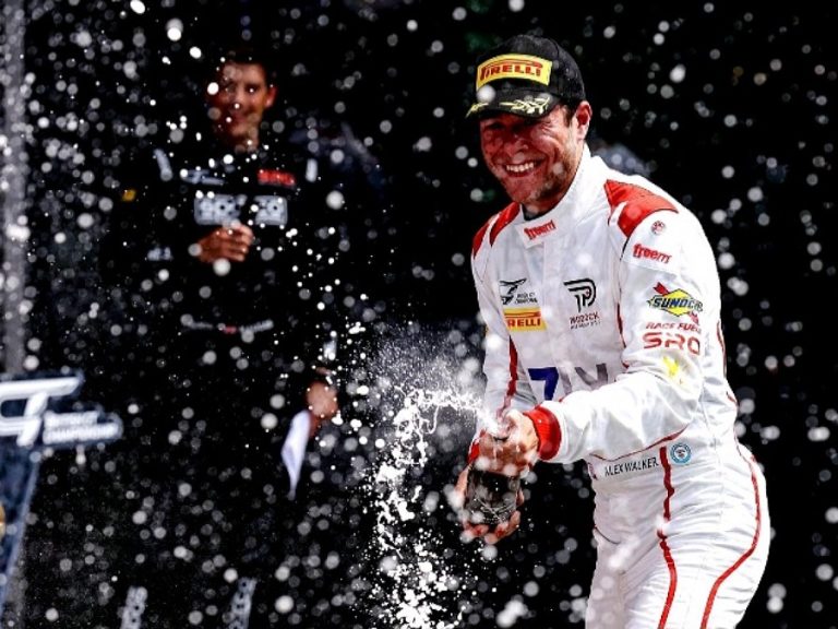 Alex Walker sprays champagne after securing another British GT Championship podium at Spa Francorchamps