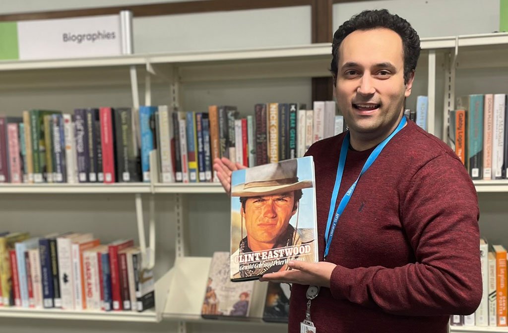 Anthony at Bedford Central Library with the long-lost library book. Image: Bedford Borough Council