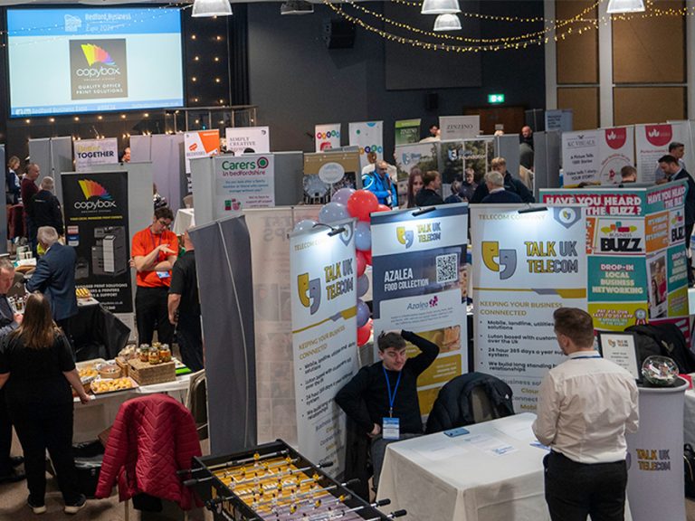 A room full of business stands and pop-up banners at the Bedford Business Expo.