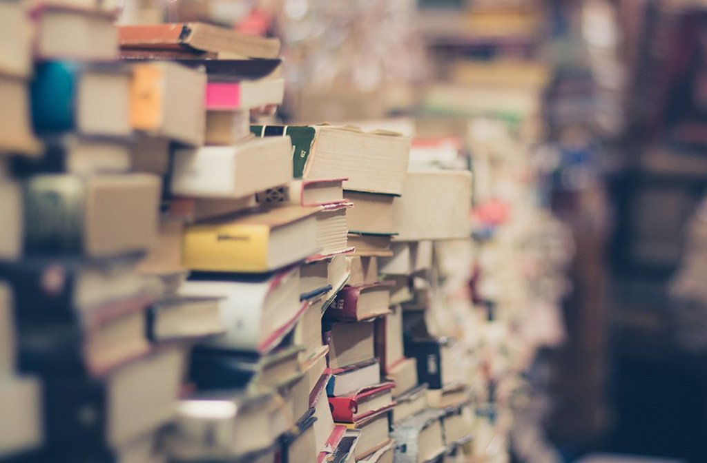 Piles of paperback and hardback books