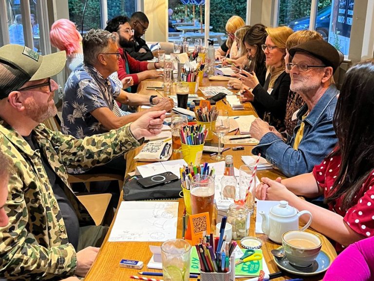 Creative people sat around the table in the Park pub taking part in the Circus of Illustration's monthly Drink and Draw