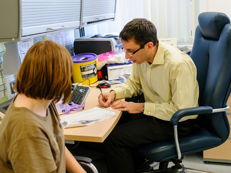 Doctor and Patient in a consulting room at a GP surgery. Image: Stephen Barnes Shutterstock