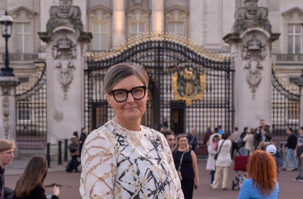 Erica Roffe, co- founder of Progress Publishing pictured outside Buckingham Palace.