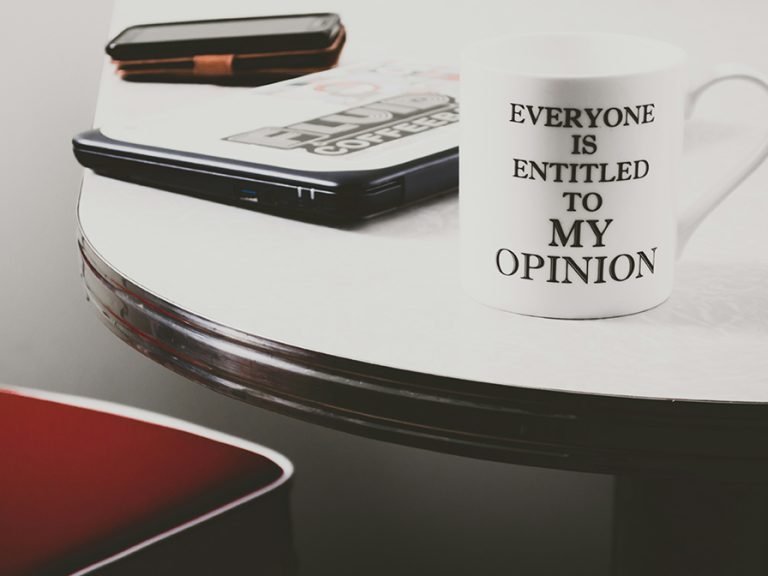 Everyone is entitled to my opinion mug on an office desk with a laptop and phone Image: Steve Johnson/Unsplash
