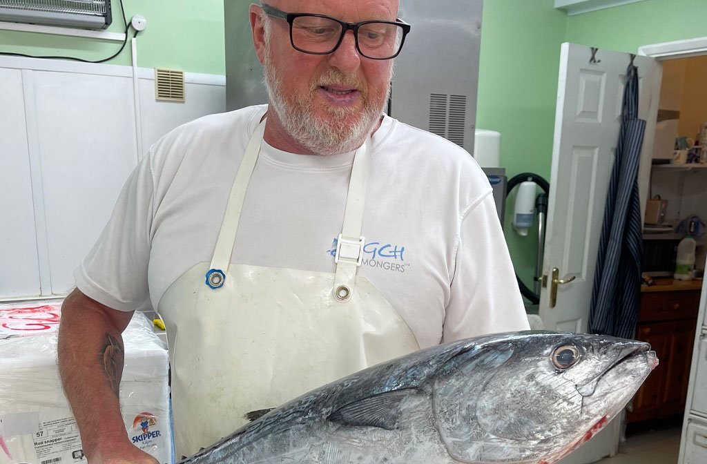 Gary Hooper of GCH Fishmongers in Bedford looking lovingly at a big fish