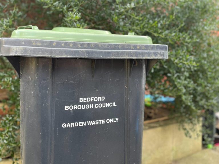 a Bedford Borough Council green wheelie bin for garden waste