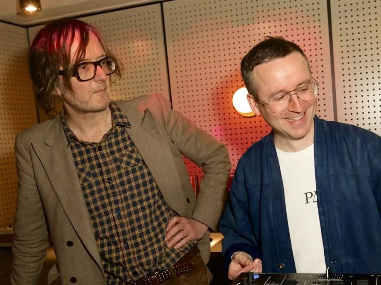 Pulp lead singer, Jarvis Cocker and Alexis Taylor of Hot Chip stand over a mixing desk.