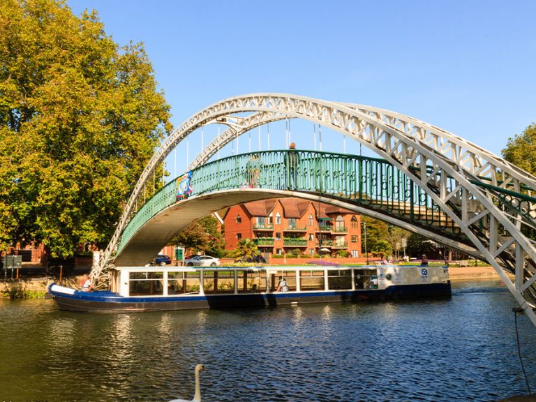 The John Bunyan Boat passing under the Suspension Bridge on the River Great Ouse, Bedford. Image: John Bunyan Community Boat