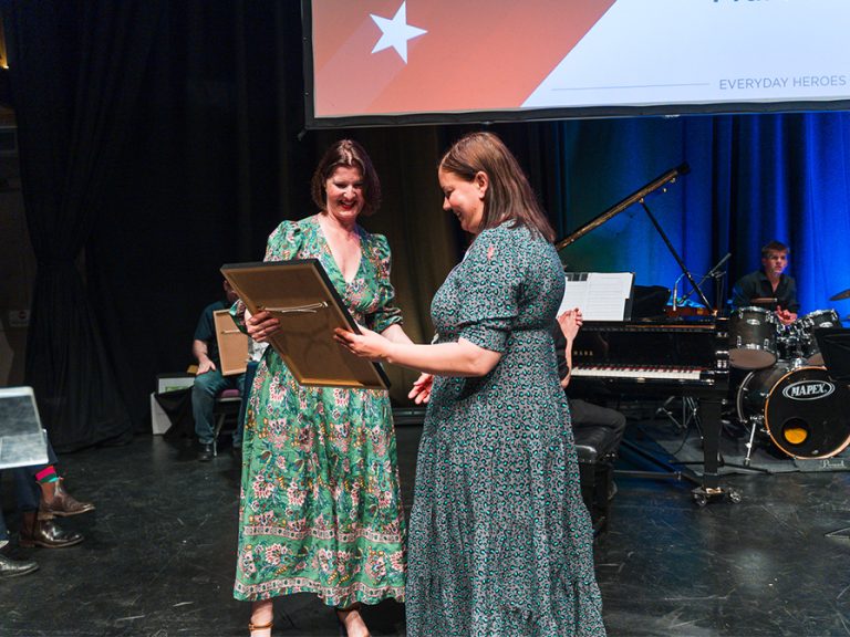 Kelly accepts the Fundraiser of the Year (Individual) Award 2024 on behalf of winner Frankie Pickup from Rebecca Covington of Woodfines Solicitors. Image: Bedford Independent