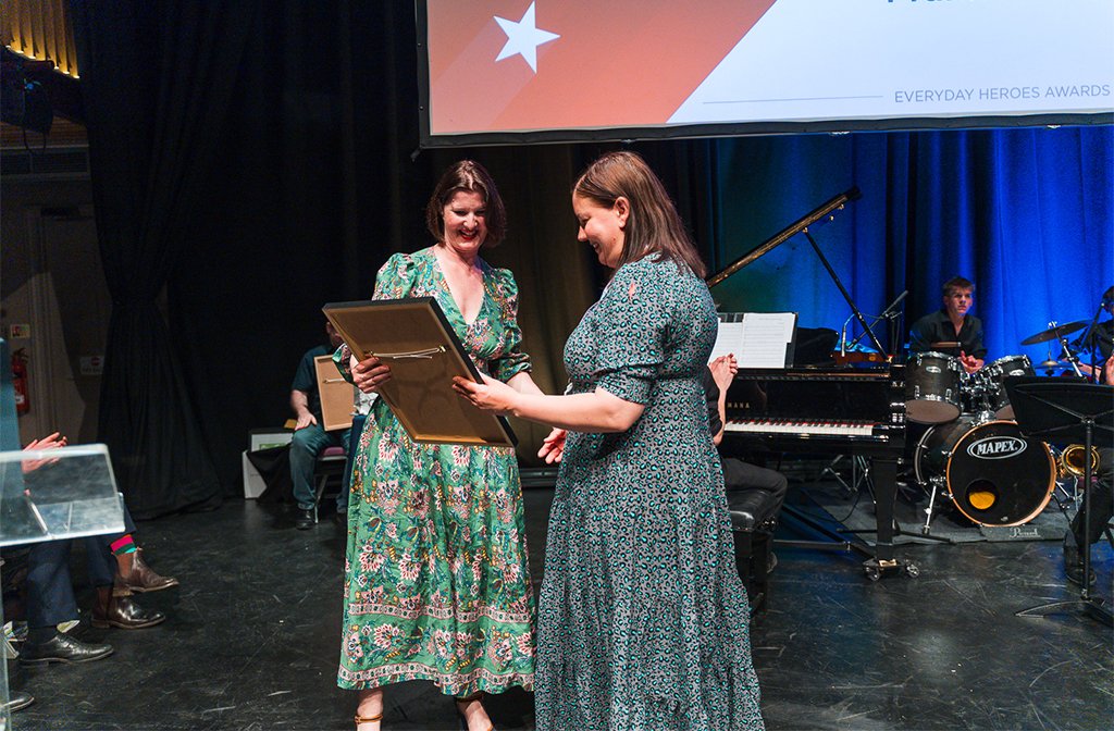 Kelly accepts the Fundraiser of the Year (Individual) Award 2024 on behalf of winner Frankie Pickup from Rebecca Covington of Woodfines Solicitors. Image: Bedford Independent