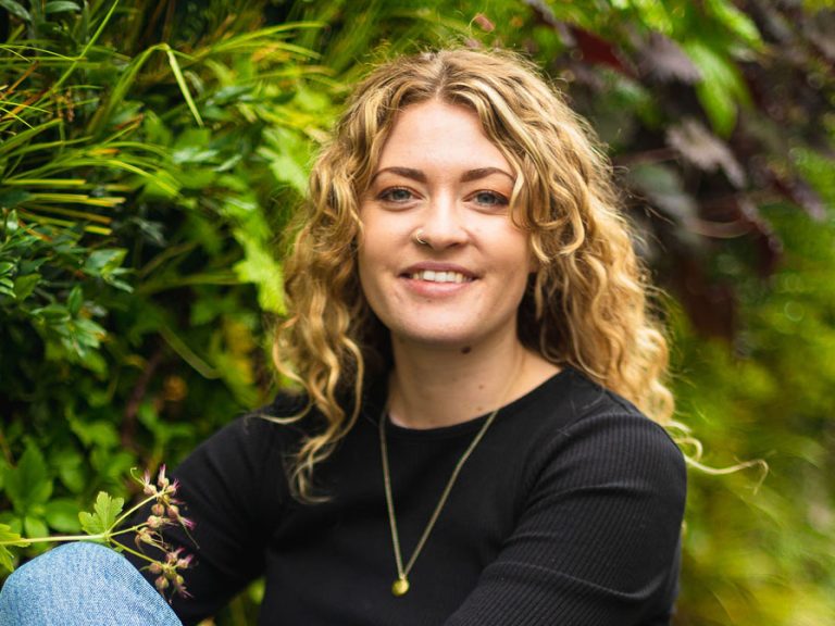 Rosanna Heasman, the owner of The Store refill shop in Bedford, is pictured in front of the plants on the vertical living wall that she installed on the outside of St Cuthbert's Arcade on St Cuthbert's Street.