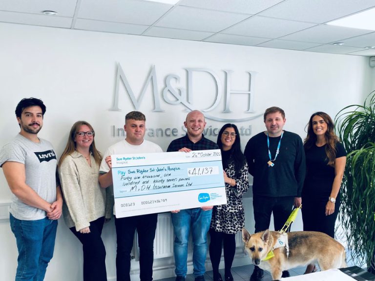 MD&H fundraising team holding a big cheque