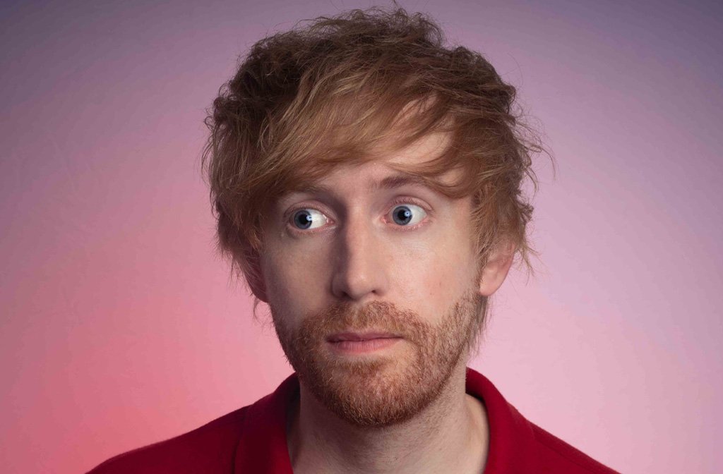 A close up of the face of comedian Mark Simmons