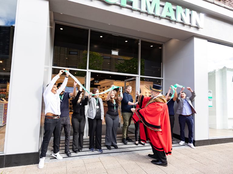 Mayor Tom Wootton celebrates with staff as he cuts the ribbon on Bedford's new Deichmann store in Bedford Town Centre. Image: Deichmann