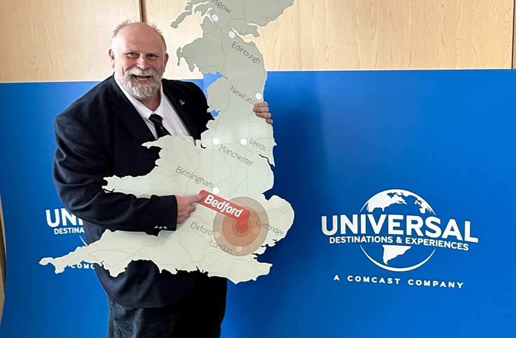 Mayor Tom Wootton holds up a cut out of the UK, showing Bedford as the the location of the proposed new Universal Studios Theme Park. Image: Bedford Independent