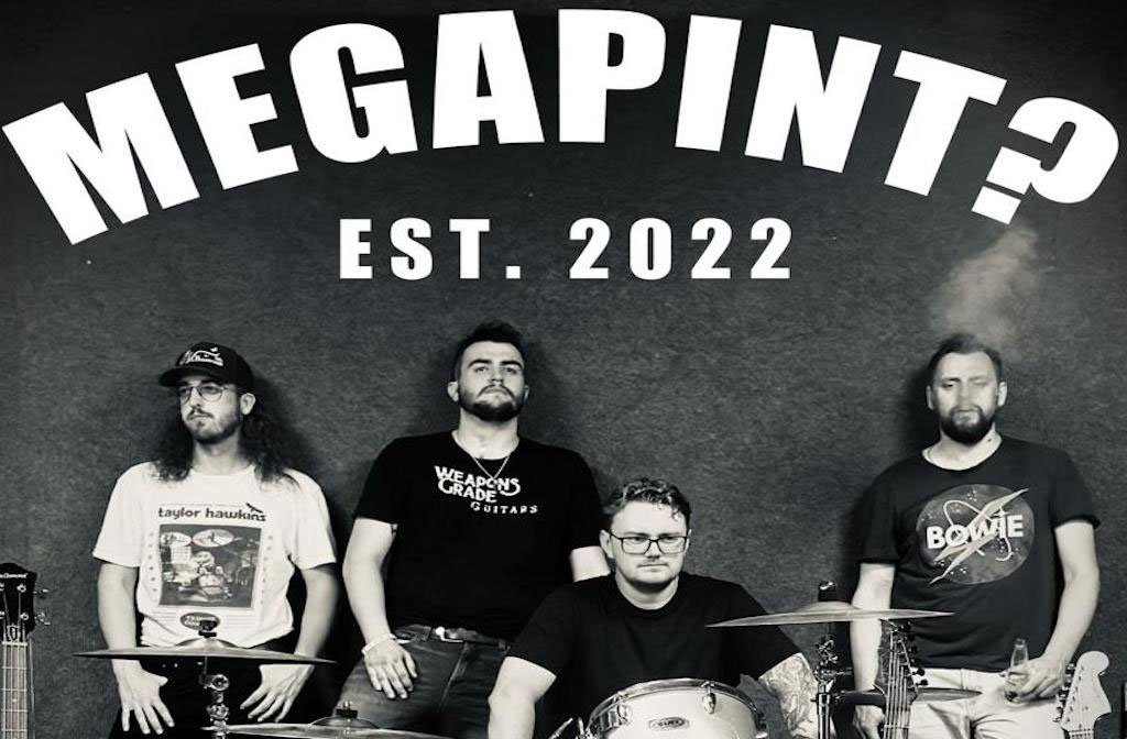 A black and white photo of the band members of Megapint? They are sat behind a drum kit and under the words MEGAPINT? Est. 2022