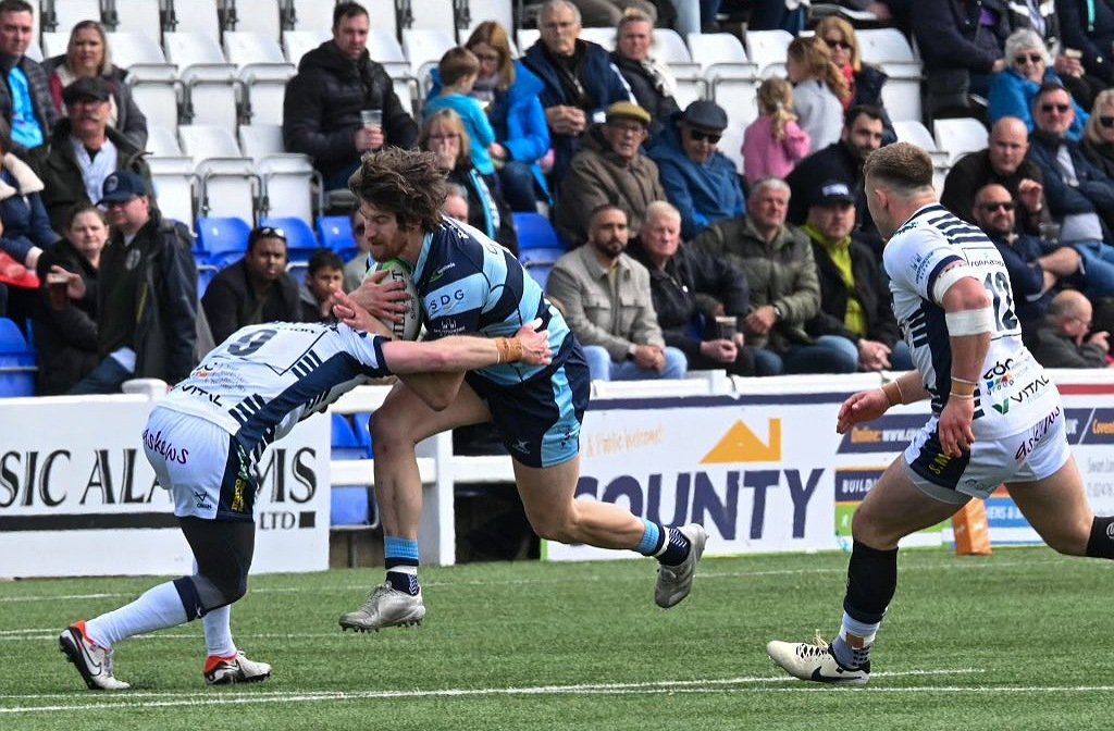 Bedford Blues' centre, Michael Le Bourgeois is tackled by a Coventry defender