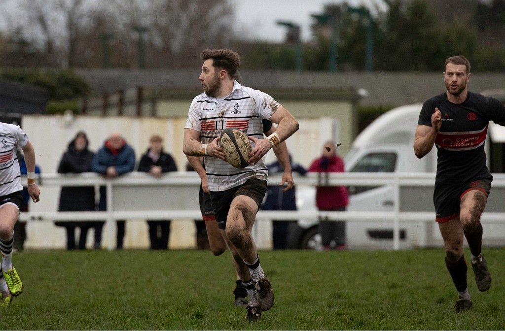 Bedford Athletic player in action