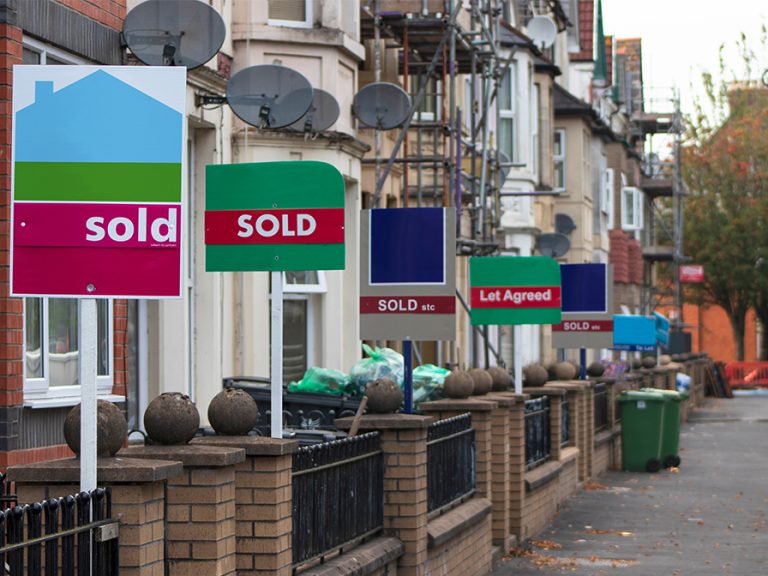 Property Sales. Estate Agents Sold Signs on UK Terraced Houses Image Mike Adobe Stock