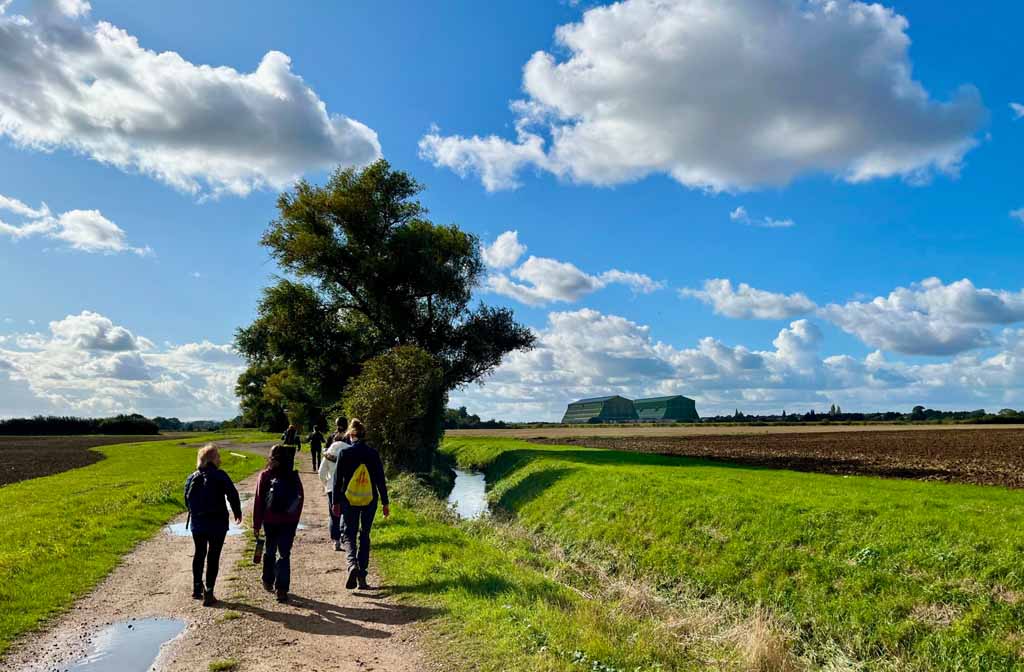 North Bedfordshire Ramblers group walking towards the hangars at Cardington