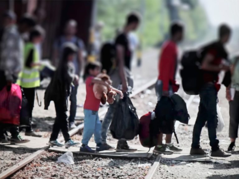 Refugees crossing a border into Europe