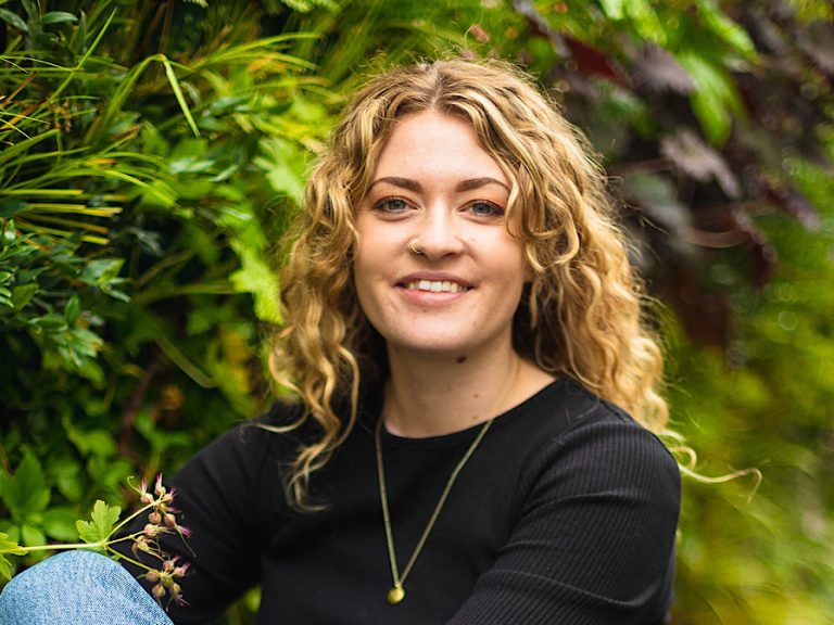 Rosanna Heasman of The Store alongside the Living Wall on St Cuthbert's Street
