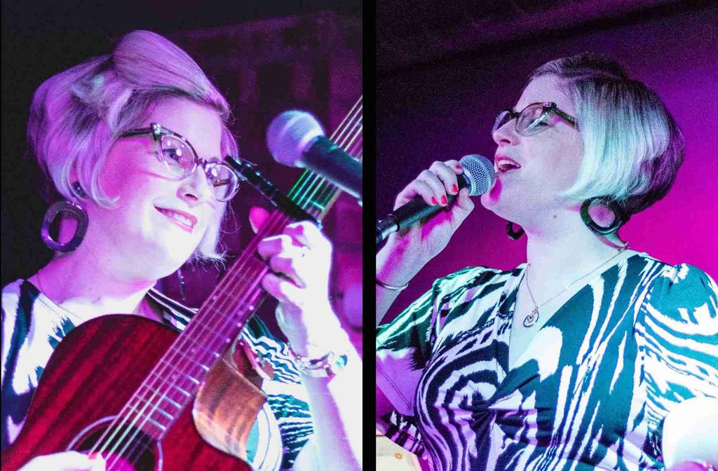 Samantha Hughes playing the guitar and singing into a microphone
