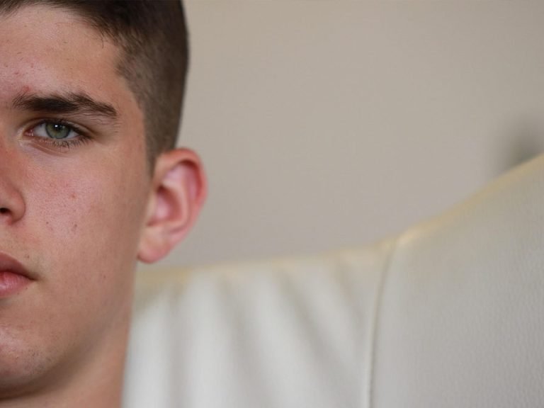 Close up photograph of a teenage boy's face.