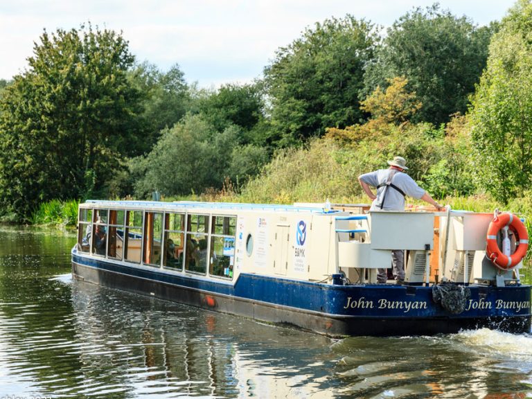 The John Bunyan Boat cruising on the River Great Ouse