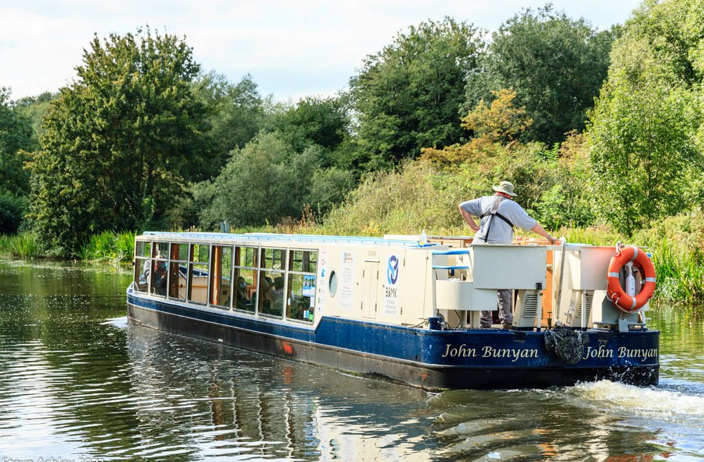 The John Bunyan Boat cruising on the River Great Ouse
