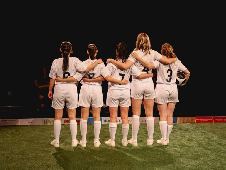 Five of the six cast with backs turned to camera in the Lost Lionesses Play