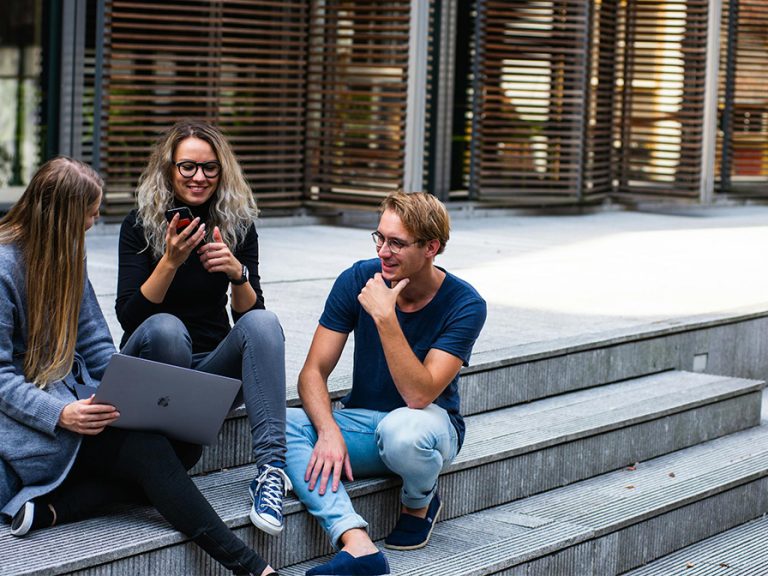 Three Persons Sitting on the Stairs Talking With Each Other. Image: Buro Millennial/Pexels