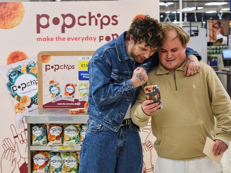 Tom Grennan with a fan during a Popchips promotion at Bedford Tesco Cardington