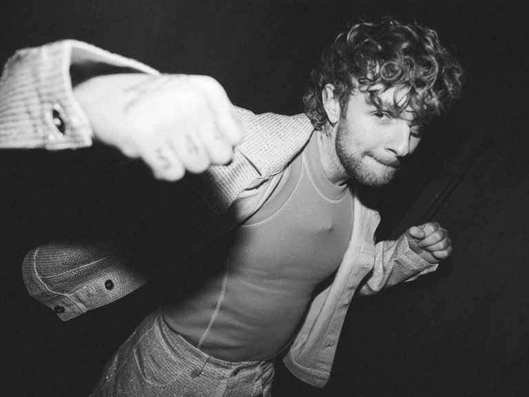 Bedford-born singer/songwriter Tom Grennan playfully punching towards the camera.