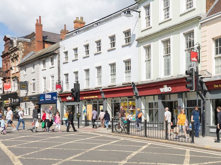 A bustling Bedford High Street on a sunny day showing Wilko store front