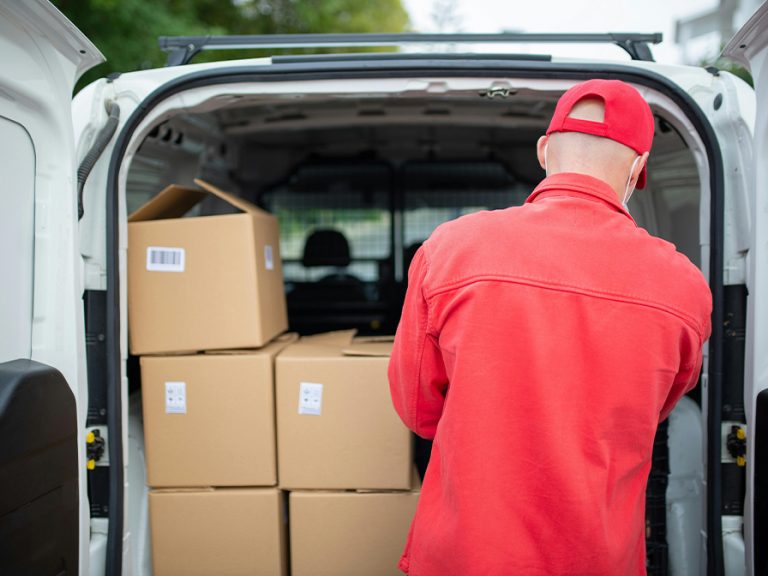 A delivery driver Arranging Cardboard Boxes in a Van Image Kampus Production Pexels