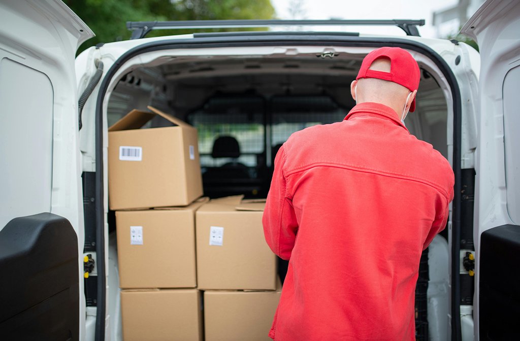 A delivery driver Arranging Cardboard Boxes in a Van Image Kampus Production Pexels