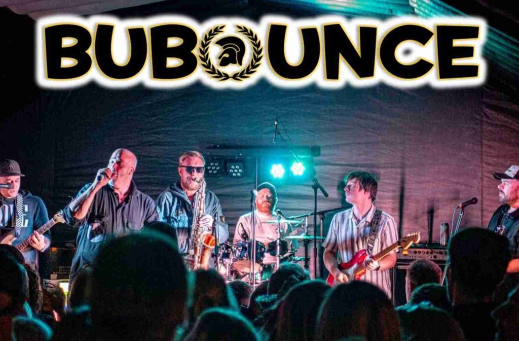 Members of the band BuBounce on stage in front of a live audience