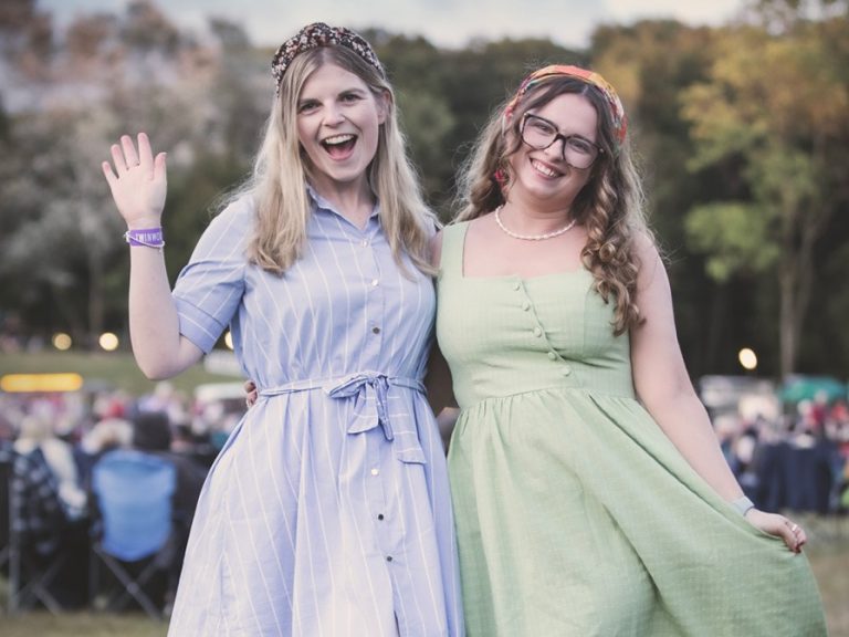 Two festival-goers in vintage attire at Twinwoods