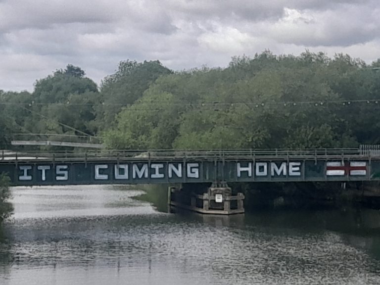 Grafitti saying 'Its coming home' with a St George's Cross on a bridge in Bedford