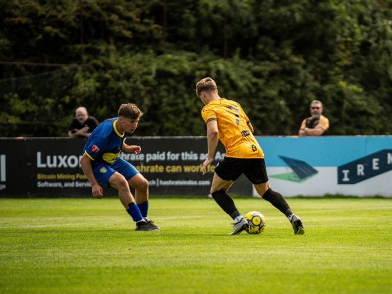 Real Bedford's Josh Setchell taking on a Spalding defender in August 2025