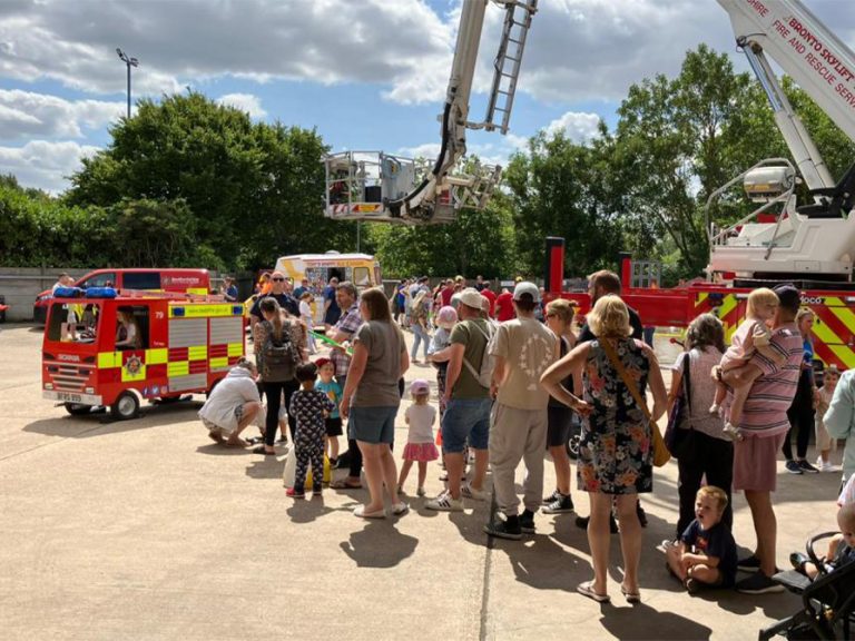 Visitors queue up to ride in a mini fire engine at Bedford Fire Station open day 9 August 2025