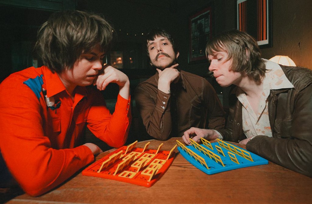 The three members of Yaang playing Guess Who?